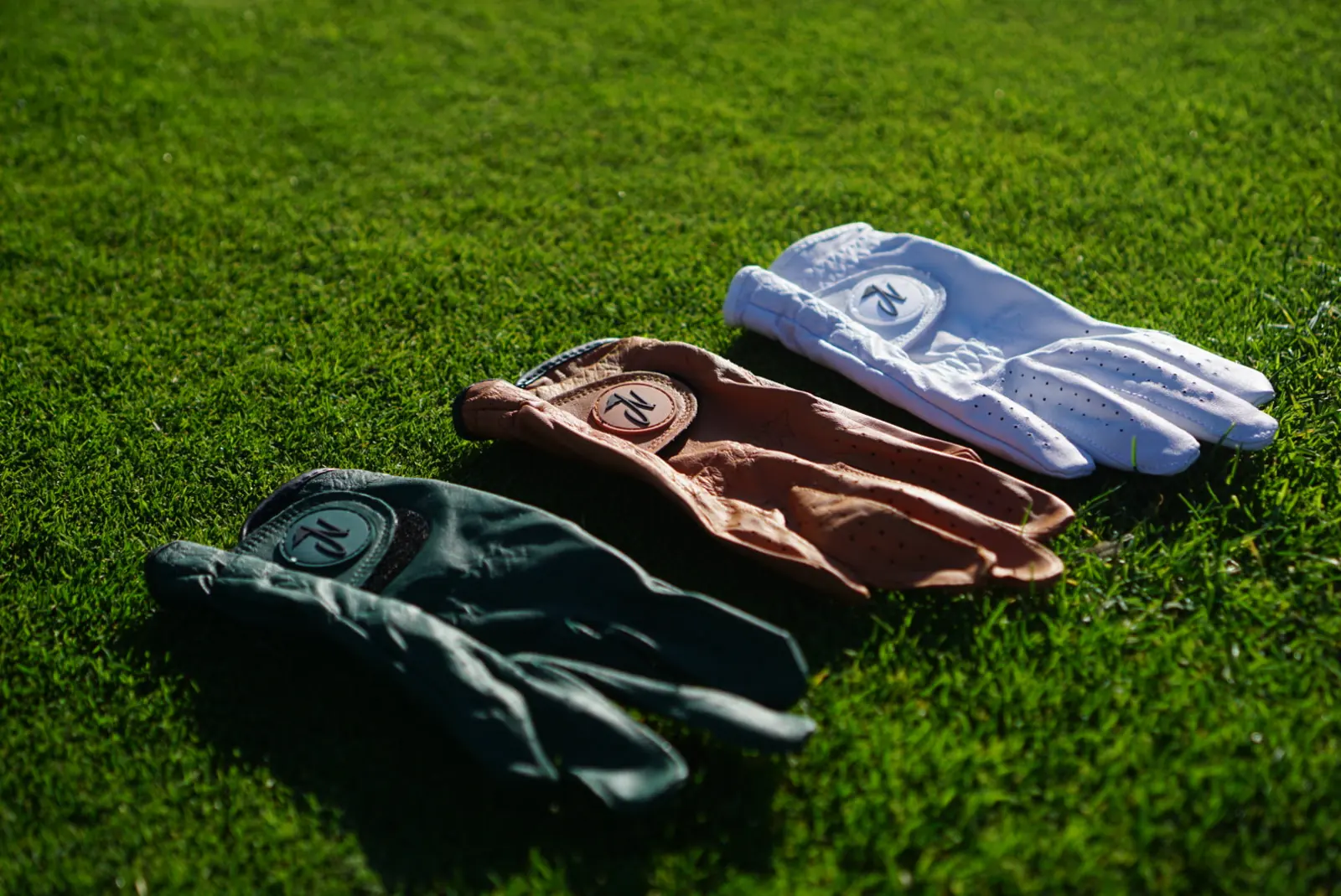 Nova golf glove on the course: gloves flat lay on grass